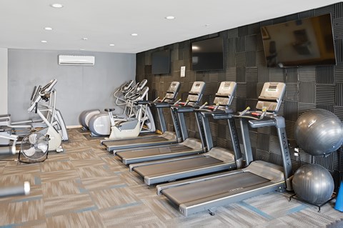 A gym here at Vue at Pinnacle Park with treadmills, exercise bikes, and other equipment.