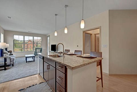 A kitchen with a table and chairs in front of a window.
