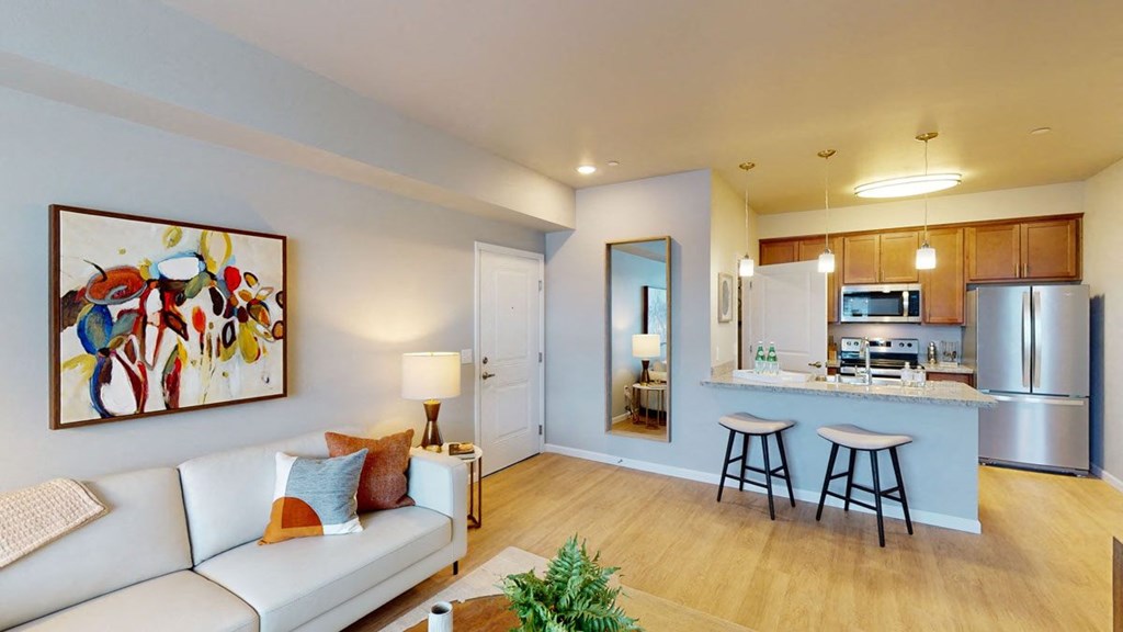 a living room with a couch and a kitchen