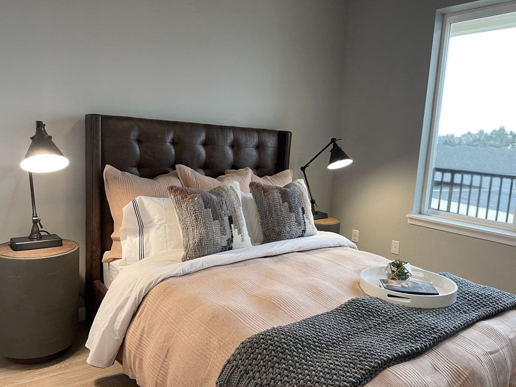 a bedroom with a large bed and a window