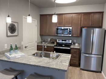 a kitchen with granite countertops and stainless steel appliances