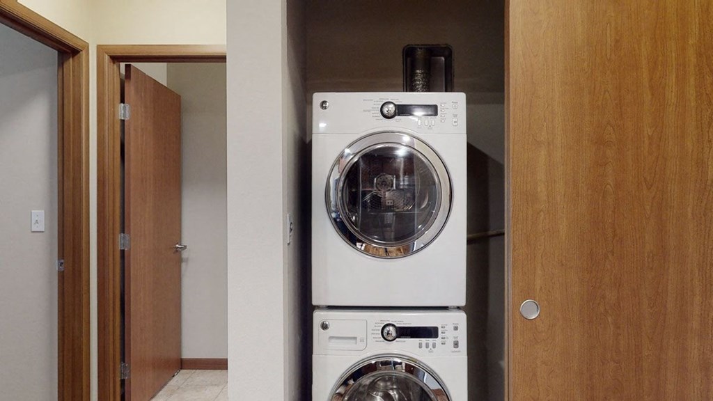 a front load washer and dryer in a laundry room