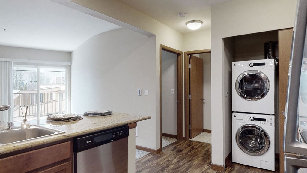 a kitchen with a washer and dryer and a sink