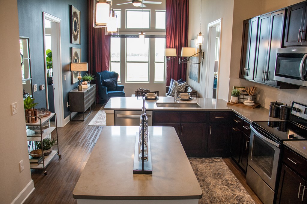 a kitchen and living room with a large window and a table