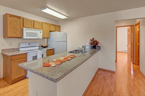 a kitchen with a granite counter top with food on it