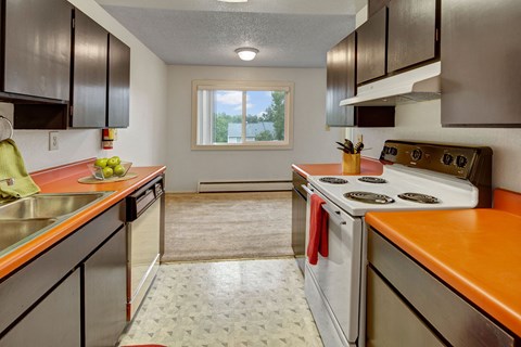 a kitchen with an orange counter top and white appliances