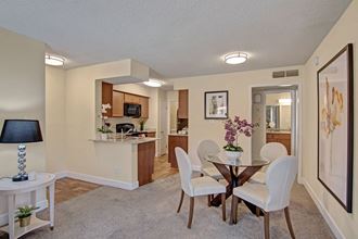 A living room with a view into the kitchen and overhead lighting Motif Living Room - Photo Gallery
