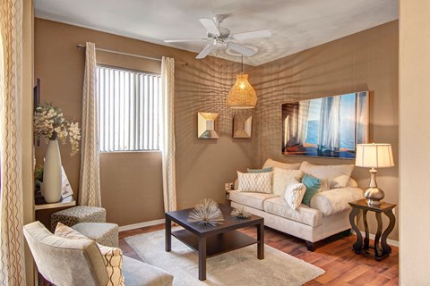 a living room with a couch and a ceiling fan