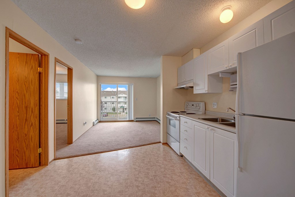 A large open kitchen with white cabinets Aspen Terrace Kitchen Apartments in Camrose, AB
