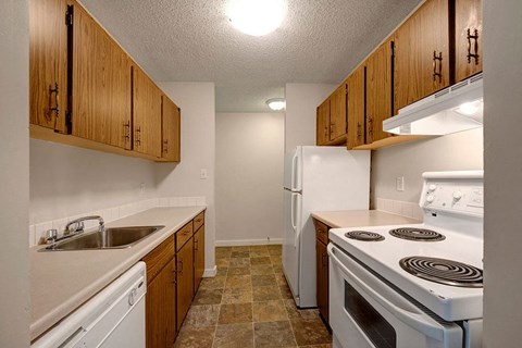 a kitchen with a stove refrigerator and sink