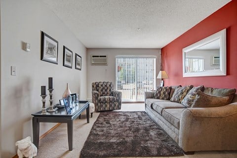 a living room with a couch and a chair and a coffee table