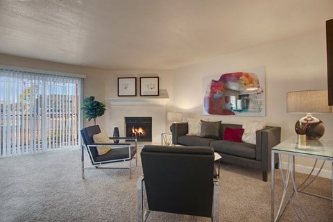 a living room with couches and chairs and a fireplace