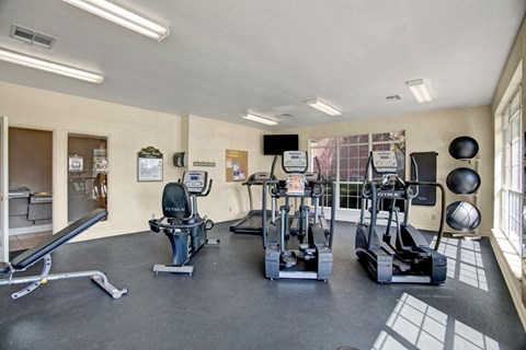 Lincoln Villas on Memorial Indoor Gym Bright gym room here at Lincoln Villas on Memorial Apartment Homes with treadmills, exercise bike, bench, and stability balls on racks. Large windows let in natural light, creating a welcoming atmosphere.