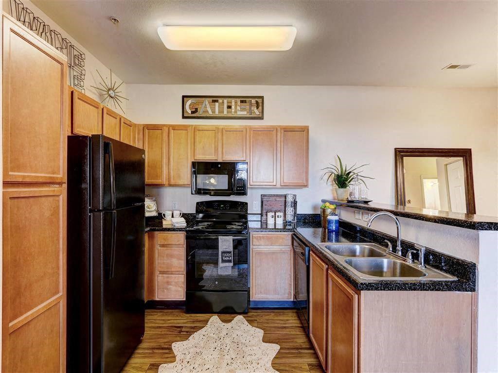 Residence at North Penn living room with hardwood flooring and granite countertops
