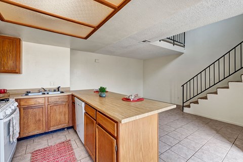 a kitchen with a counter top and a sink and a spiral staircase