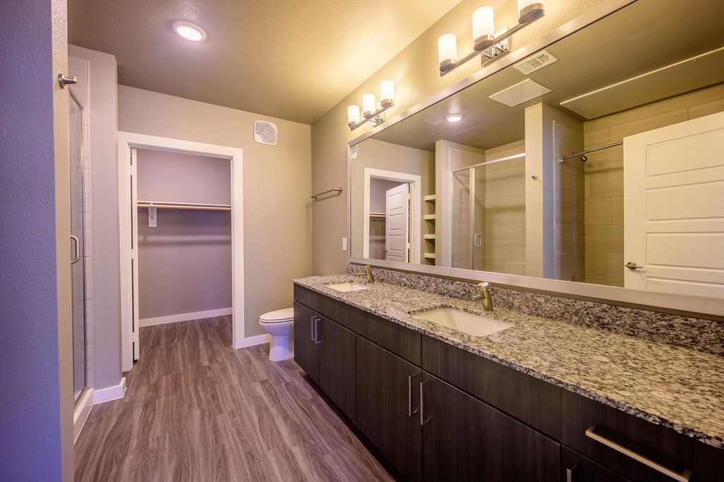 Harmony Luxury Apartments large bathroom with wooden floors