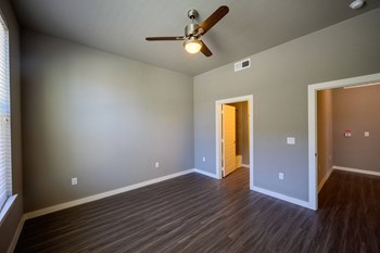 Harmony Luxury Apartments large bedroom with ceiling fan and tall ceilings - Photo Gallery 14