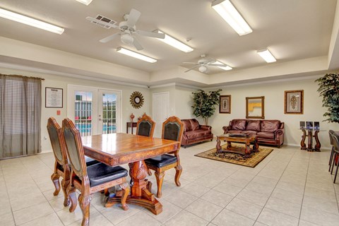 a dining room with a table and chairs and a living room with couches