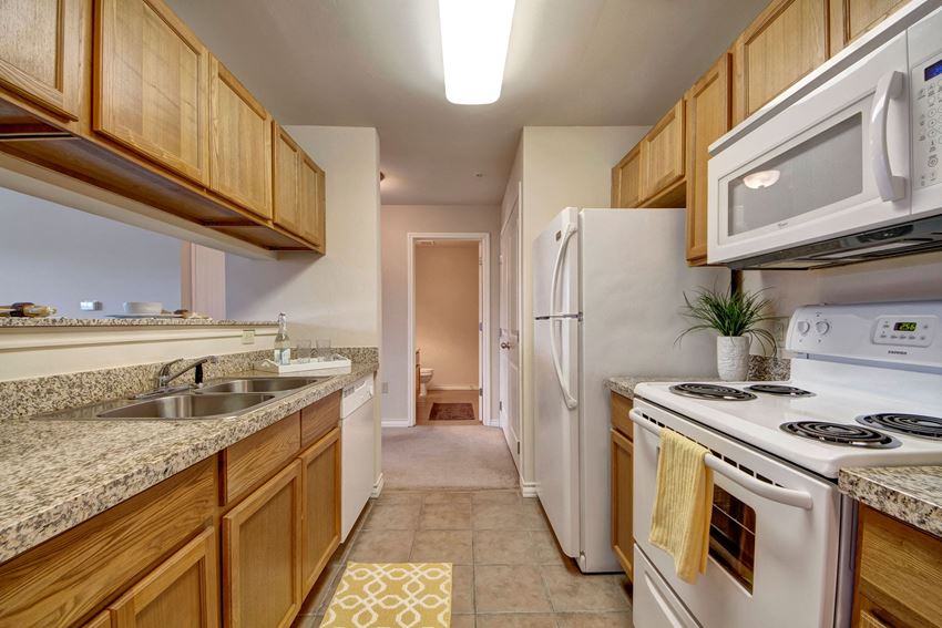 Galley style kitchen with granite countertops and a breakfast bar Reserve at Abilene Kitchen Apartment Rentals Abilene, TX