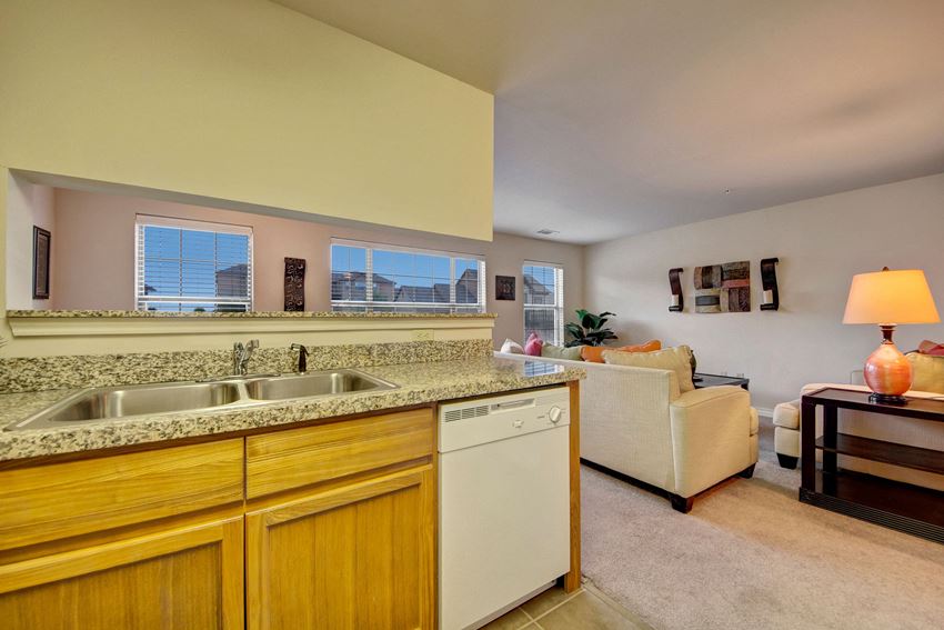 A kitchen with lots of cabinet storage, double sinks, and granite countertops Reserve at Abilene Kitchen Abilene Apartments
