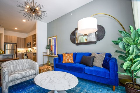 a living room with a blue couch and a coffee table