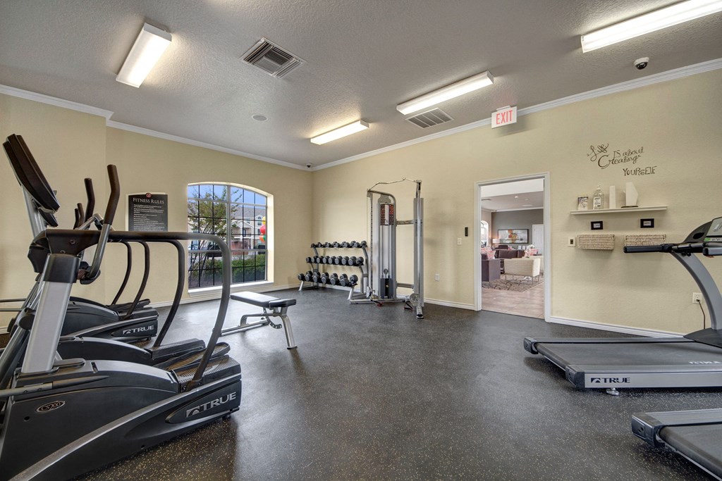 A shared gym with stair steppers, treadmills, and weights Residence at Heritage Park Gym Abilene Apartments