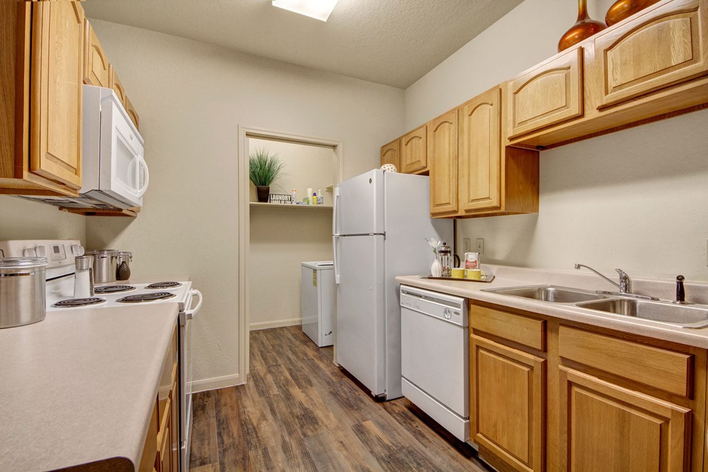 An open kitchen with lots of cabinet storage and easy access to the laundry room Residence at Heritage Park Kitchen Apartments for rent in Abilene, TX