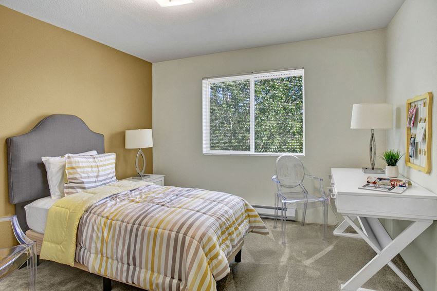 Bedroom with bed, desk, and window Allegro Bedroom Apartments in Covington, WA - Photo Gallery
