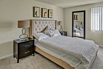 Furnished large bedroom with natural lighting at Andorra Apartments in Mountlake Terrace, WA