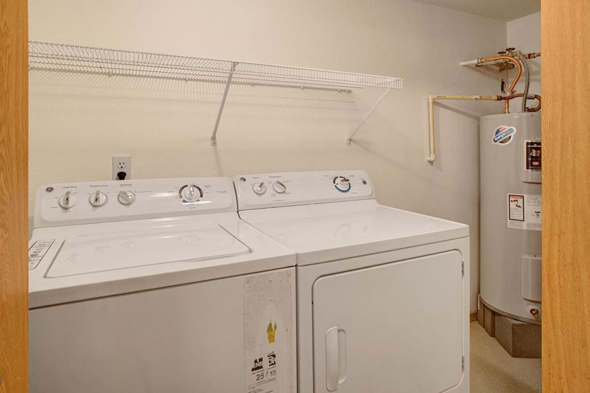 A full size washer and dryer in a closet off the living room next to the water heater Lake Park Laundry Apartments in Everett, WA