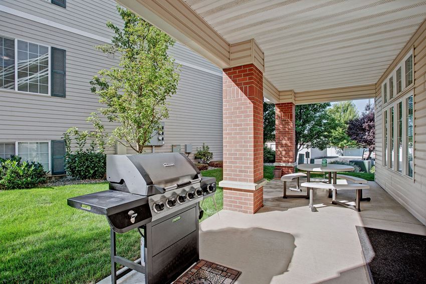 A barbeque and patio table for resident use Lion's Gate Exterior