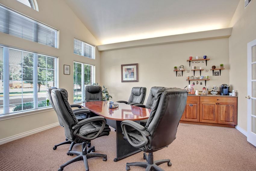 A conference room for resident use with six chairs and a long table Lion's Gate Conference Room