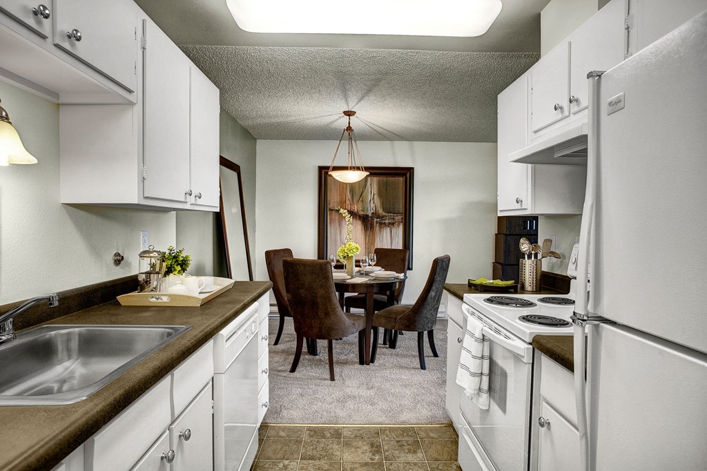 A kitchen with plenty of counter space, dishwasher, and lots of cabinet storage Overlook at Magnolia Kitchen Apartments in Seattle, WA