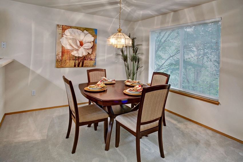 A cozy dining area off the kitchen with a large window and overhead lighting Sunrise Lane Dining Apartments in Everett, WA - Photo Gallery
