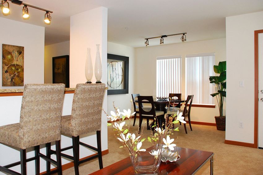 Living area facing the dining area with large windows Viewpoint Living Room Apartments in SeaTac, WA - Photo Gallery