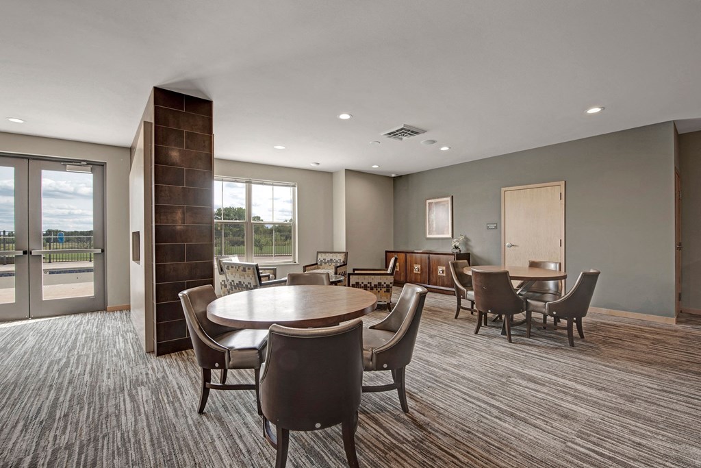 The Clubhouse at The Vue at Pinnacle Peak Apartment Homes Apartments in Fitchburg, WIed with furniture and a large window
