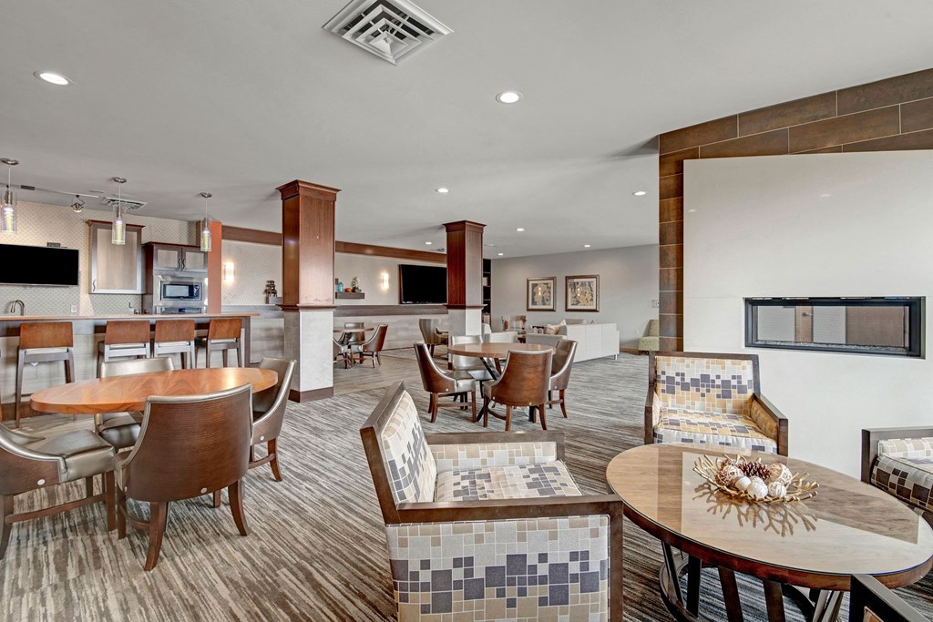 The Clubhouse at The Vue at Pinnacle Peak Apartment Homes Apartments in Fitchburg, WIed with furniture and a large window