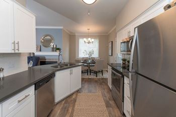 a kitchen with stainless steel appliances and white cabinets