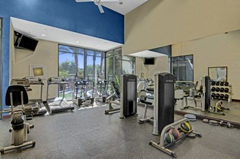 A gym for resident use with machines, free weights, and yoga materials Property Image
