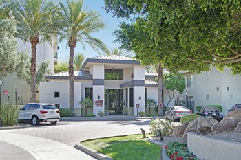 The exterior of the building surrounded by grass and trees Property Image