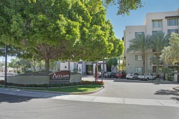 The exterior of the building surrounded by grass and trees Property Image