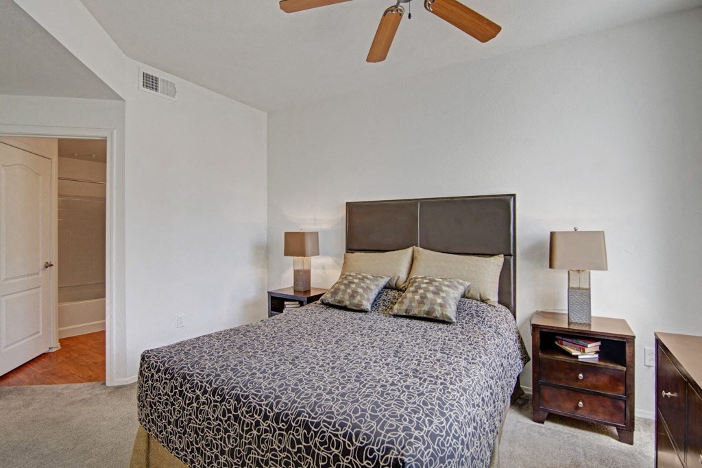 Acclaim Apartments- furnished bedroom with ceiling fan 