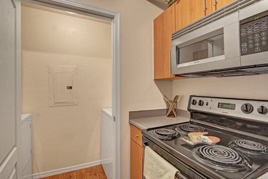 Acclaim Apartments- kitchen with a stainless-steel stove and microwave
