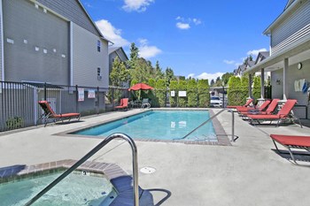 Outdoor pool with lounge chairs and separate hot tub Allegro Pool - Photo Gallery 6