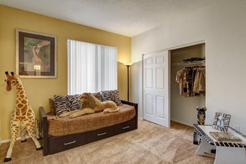 a bedroom with a large bed with a stuffed giraffe on it and a closet with a - Photo Gallery 8