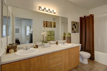a bathroom with two sinks and a toilet - Photo Gallery 13
