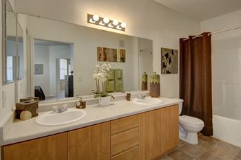 a bathroom with two sinks and a toilet