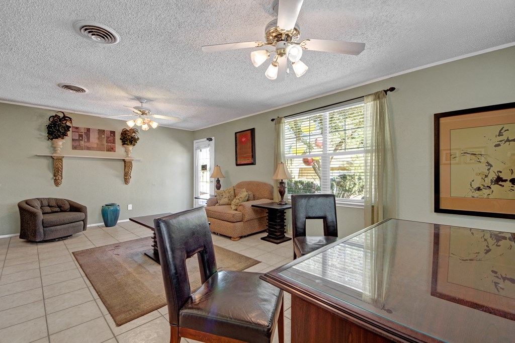 a dining room and living room with a table and chairs