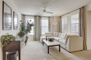 A living room with multiple windows and a ceiling fan Bela Rosa Living Room - Photo Gallery 5