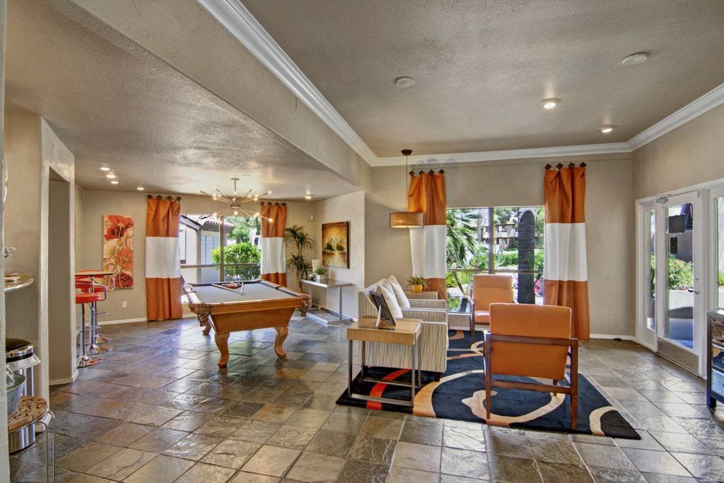 a clubhouse with a pool table and chairs